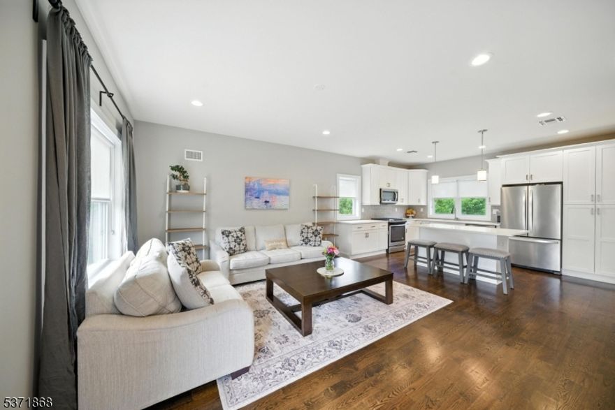 Welcome to the Brownstones at Fairfield! Built in 2018, this 3-level end-unit townhome offers modern living with hardwood floors, energy-efficient windows/doors, tankless hot water heater, and multi-zone heating/cooling. The first level features a foyer, garage entry, laundry room, storage, and backyard access. The open-concept second level offers a white shaker kitchen with quartz counters, center island, pantry, living room, powder room, and balcony. The third level features 2 ensuite bedrooms. The primary suite includes double closets with custom built-ins and a luxury bath with oversized tile shower and quartz vanity. The second ensuite offers a full bath and a closet. Top Rated Schools. Minutes to NYC transit, shopping, and major highways. Not in a flood zone.