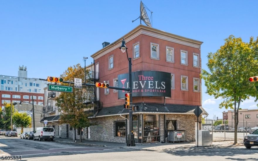 A rare opportunity to acquire a fully income-producing mixed-use property in the heart of Downtown Newark's Arena District, steps from the Prudential Center and Mulberry Commons Park. 218 Mulberry Street offers immediate cash flow with significant long-term upside in one of Newark's most active redevelopment corridors. The property features a strong commercial anchor tenant generating approximately $240,000 annually, plus four residential units above, providing a diversified income stream with total annual income of approximately $349,200 and a net operating income of approximately $291,900. Operating expenses are low, tenants pay all utilities, and the property is owner-managed. All leases are month-to-month, offering incoming ownership flexibility to lock in long-term leases, optimize rents, or reposition the asset. Located within a major redevelopment zone surrounded by substantial public and private investment, the property is widely regarded as a strategic parcel in the continued transformation of Downtown Newark. Ideal for 1031 exchange buyers, long-term hold investors, value-add strategies, or assemblage-minded buyers seeking stable income today with meaningful future potential.