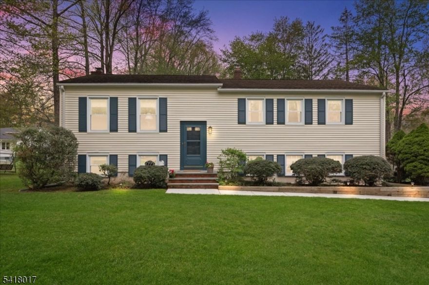 Move right into this meticulously renovated 4-bedroom, 3-bath residence, perfectly positioned just 0.3 miles from Mountain Park Elementary and minutes from the NYC train and downtown Berkeley Heights. The 2022 stunning kitchen features Silestone countertops, crisp white cabinetry, a breakfast bar and stainless steel appliances, and opens to the formal dining room.The sliding glass doors leads to a spacious deck perfect for indoor/outdoor entertaining.The inviting living room is ideally situated for gatherings, while the primary suite offers a full bath and his/her closets. Two additional bedrooms and a renovated hall bath complete the main level.The lower level provides additional living space, including a large family room with a brick fireplace and sliding glass doors to backyard and a renovated full bath (2024). The fourth bedroom with built-in cabinetry, double closets and a barn door opening to the Family Room is ideal as a guest suite, a home office, or flexible living. Set on .48 acres, the outdoor space boasts an expansive front lawn, a large deck and a tranquil, wooded backyard setting. Additional highlights: refinished hardwood floors, new carpet, recessed lighting, recently painted interior, tile floor in mud room, oversized two-car garage, driveway and walkways (2025) and AC/Furnace (2020). This home is truly turnkey.
