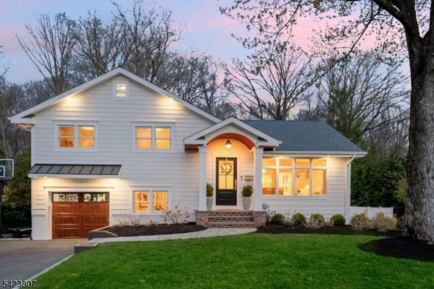 98 North Summit Ave. is a masterfully reimagined residence, designed for the way you live today. This home showcases exceptional natural light and exquisitely curated interiors. The private backyard retreat is a personal oasis just moments from town, train, & schools. Enjoy the newly installed premium Hardie Plank siding, Andersen windows, a custom-designed portico with ambient lighting, & an expansive Trex deck featuring dry storage & under-deck lighting. A stunning screened-in porch flows effortlessly to a paver patio and lush green grounds, creating an idyllic setting for entertaining. Tucked within a quiet enclave of 4 dead-end streets, the neighborhood is perfect for bike rides, outdoor play, and peaceful living. Inside, the formal LR exudes warmth and sophistication, anchored by a sun-drenched bay window and a bespoke dry bar that connects to an elegant DR. The open-concept kitchen and FR are designed for both everyday luxury and effortless entertaining, featuring a 7-foot quartz island, premium S/S appliances, custom cabinetry, and a gas fireplace & refined mantle. The second level offers a tranquil primary suite with dual closets, two additional bedrooms, and a beautifully appointed full bath with marble vanity. A pull-down attic provides generous additional storage while the ground level is equally impressive, featuring a mudroom with custom cubbies, a laundry room, a verstile fourth bedroom, and access to the garage, finished basement, and backyard.