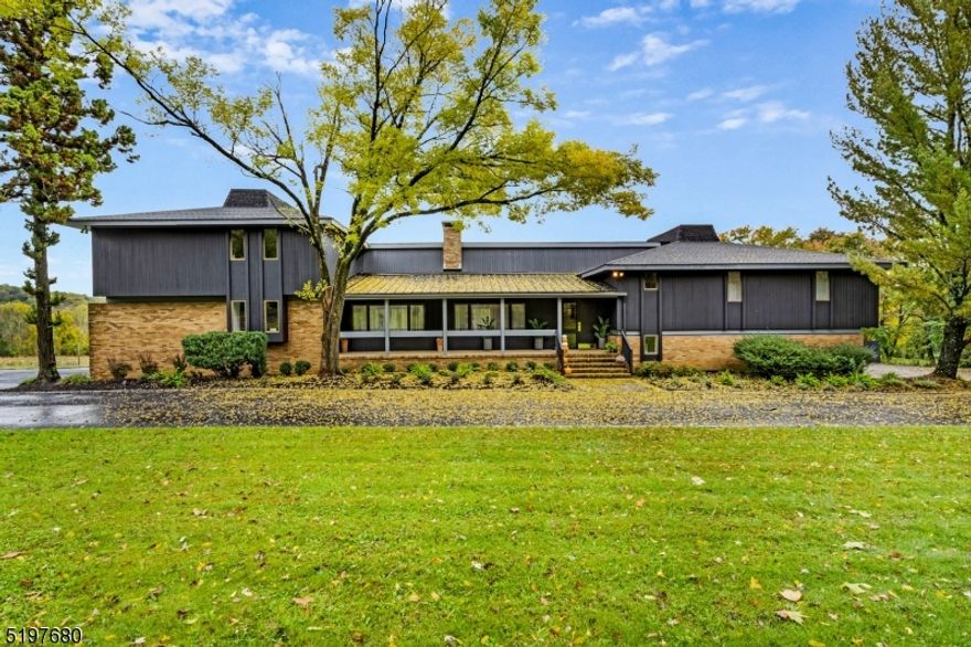 A modern farmhouse like you've never seen! This 6,627 square foot mid-century modern home sits on 34+ acres of rolling farmland. Located on the border of Peapack-Gladstone and within walking distances from one of the most acclaimed private schools in NJ, Gil St Bernards, this is a truly unique opportunity. 32 of the 34 acres have been farm assessed and is also approved for equestrian use. Upon entering you are greeted by an 'artist gallery' style foyer which leads you into a newly renovated kitchen drenched in natural light from the wall of oversized windows looking out on to spectacular country views. Contemporary touches mixed with traditional finishes such as the large stone fireplace and oversized barn style doors, brings an air of elegance yet coziness to each space. Every room including the exterior has been freshly painted and boasts all new lighting throughout. 4 of the 5 bedrooms include private balconies overlooking the tennis courts and bluestone patio below. A potential in-law suite complete with a renovated full bath, kitchenette, fireplace and private entrance resides on one half of the lower level. The other half is an entertainers dream with a full-sized retro inspired bar and plenty of room for a home theater, game room, etc. Enjoy this tranquil escape of country living without giving up any of the luxury and design of contemporary style!