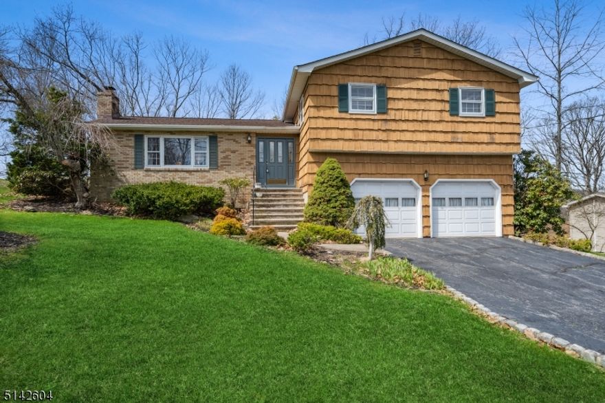 Wonderful split with a great curb appeal in prime Kinnelon location is looking for new owners!!  All public utilities: water, sewer, and gas.   First floor features large living room with big windows and wood burning fireplace; updated beautiful kitchen with an island, granite counter tops, stainless-steel appliances, and door to a deck; formal dining room.  Second floor invites you with its master suite offering renovated mater bath and three other spacious bedrooms, main bathroom.  Ground level will impress you with spacious family room opening to an amazing, huge, heated sunroom providing access to the backyard - peace, and tranquility.  Two car garage and large deck complete the picture of a wonderful home. Top rated school system! Very conveniently located home to shopping, restaurants, parks, schools, and highway!  Come and stay!