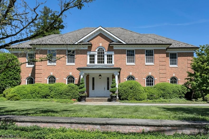 Designed by renowned architect Al Boles and meticulously custom built in 1991 by John McFadden, this luxurious residence encompasses 8,700 square feet of pure elegance and modern comfort. The home's tremendous curb appeal is further enhanced by its brick exterior and timeless slate roof. You cannot beat the location of this home, perfectly situated just half a mile from the Short Hills Train Station, with direct lines to NYC, and a mere quarter mile from the top-rated Glenwood Elementary School and the Arboretum. As you step into the grand two-story foyer, you will be captivated by the impressive great room, featuring floor-to-ceiling french doors that flood the space with natural light. The expansive patio offers a tranquil retreat, overlooking a beautifully landscaped backyard complete with a pool, waterfalls, and a jacuzzi. With six spacious bedrooms, including a ground-floor primary suite, six full bathrooms, and a half bath, this home provides ample space for everyone. The gourmet kitchen, formal dining room, expansive living area, and two offices ensure both comfort and convenience for everyday living. The fully finished basement offers versatile space for a gym, media room, and more, while the nanny quarters above the garage provide additional accommodation. The three-car garage and recently repaved driveway offer plenty of parking. Don't miss your chance to own this magnificent home in a prime location!