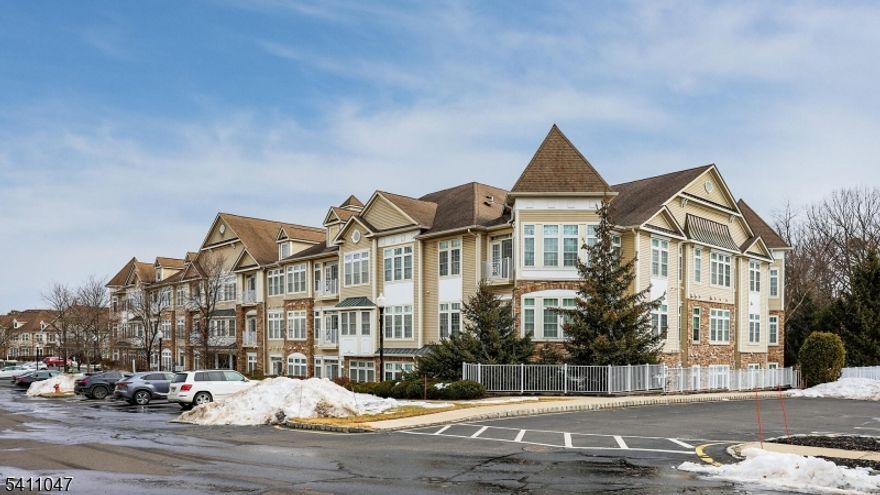 Welcome to the Barkalew Model offering 1,400 sq ft of comfortable, low-maintenance living in the sought after Cedar Village 55+ gated community. The second-floor private unit backs to a tranquil wooded area, providing peaceful views and exceptional privacy. Enter through a welcoming foyer with an oversized hall closet while enjoying a lot of natural, well-lit light and the airy interior with 9 foot ceilings. Step into the kitchen which boasts abundant light oak cabinetry with pull-out shelves, marble backsplash and an extended counter area. The kitchen opens seamlessly to the living room, creating an open floor plan. The separate dining area is perfect for entertaining or everyday living. The primary bedroom features a walk-in closet and private bath with soaking tub and separate stall shower. The second bedroom is thoughtfully situated on the other side of the home. Ample closet space throughout enhances everyday convenience. Major mechanical updates include a two-year old HVAC system and water heater, offering peace of mind. The elevator building provides access to an assigned private underground parking garage with an additional storage area. Residents enjoy an exceptional clubhouse with outstanding amenities, including a heated outdoor pool, fitness center, sauna, recreation rooms and a full calendar of social events.Conveniently located near shopping, dining and transportation. Cedar Village offers an active lifestyle with the ease and comfort of community living.