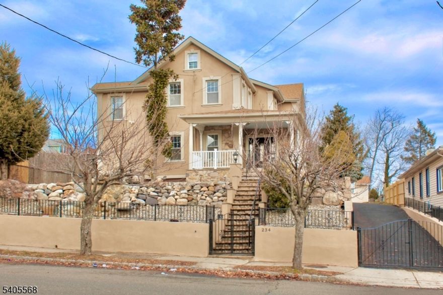 A true one-of-one Colonial Revival custom home unlike anything else in the neighborhood. Rebuilt with intention, fully brought up to code. The next chapter begins with nothing to do but unpack. Outside sculpted stonework and a serene waterfall feature give the home warmth and personality. The entry opens to an oversized foyer setting the tone for the architectural detail ahead. A sun-filled reading nook invites quiet mornings leading into a living room and formal dining room with rich honey-toned hardwood floors framed by custom dark inlay borders a stone fireplace and layered ceiling millwork with recessed trays and graceful arches. The dining room reveals a grand symmetrical kitchen centered around a statement island, integrated cooktop perfect for hosting. Soft taupe cabinetry warm stone countertops designer backsplash and full appliance package complete the space. A guest half bath sits just opposite. Also on this level the primary suite features a large closet and dressing room just before the suite with stone-clad walk-in shower. Upstairs offers 5 bedrooms,1 ideal as a home office, a full bath and one bedroom with a private balcony. Custom hardwood border detailing throughout-craftsmanship rarely seen today. A finished basement includes laundry and flexible living space. Outside, 8+ car driveway leads to storage shed accented by large arched Palladian window. With space and quality unmatched in the area this home is a rare find that quietly elevates the entire street.