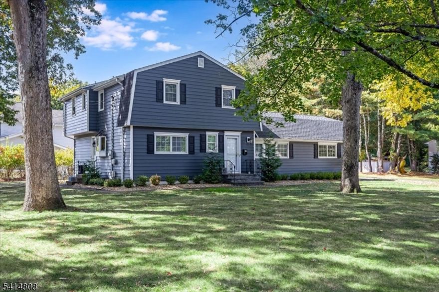 Located in the desirable Broadlawn section of Livingston, this home offers thoughtful updates, and three finished levels of living space on a level lot.A welcoming foyer leads into bright and airy living and dining spaces featuring hardwood floors that continue throughout much of the home. The updated eat-in kitchen offers granite countertops, two sinks and two dishwashers, stainless steel appliances, tile backsplash, newer flooring and a breakfast area along with a convenient side door entry. The spacious family room features sliding doors that open to the deck and backyard, creating a seamless connection to outdoor living. A first-floor powder room and a laundry room with pantry and newly tiled flooring add everyday convenience.Upstairs, the primary bedroom includes two large double closets and an ensuite bath with a glass-enclosed shower. Three additional generously sized bedrooms feature new carpeting and share a hall bathroom.The finished lower level provides additional living space, a recreation room and ample storage.Recent improvements include freshly painted interior, new siding, new roof, rebuilt front steps, new generator, recessed lighting, new light fixtures, new baseboards, new hot water heater, and newer Pella/Anderson windows.Enjoy outdoor living on the spacious deck overlooking the level backyard surrounded by mature trees.The home is ideally situated near everyday conveniences including Livingston Town Center, parks, schools, and houses of worship.