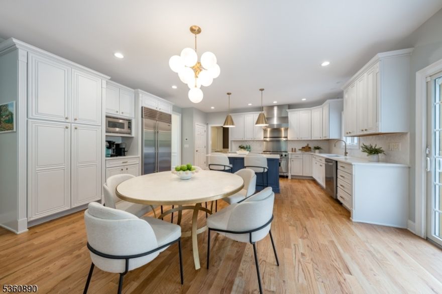 BRIGHT, EXPANSIVE COLONIAL ON QUIET CUL-DE-SAC W/ STUNNING BACKYARD OASIS! Show-stopping curb appeal w/ lush, manicured landscaping welcomes you to this elegant, sun-drenched home. Step inside a soaring 2-story Foyer flooded w/ natural light. Hardwood floors, rich moldings, & timeless architectural details set the tone throughout. The spacious Living & Dining Rooms offer seamless entertaining, highlighted by bay windows, custom inlaid hardwood floors, & striking millwork. Recently renovated, the gourmet Eat-In Kitchen stuns w/ high-end Viking & Sub-Zero SS appliances, crisp white cabinetry, quartz countertops, Center Island, & Coffee Bar. The open-concept layout connects to the large Family Room & Dining Area. The Family Room is bright & welcoming w/ gas fireplace framed by built-ins, & access to newly refinished deck, ideal for indoor-outdoor living. Upstairs, Laundry & 3 spacious Bedrooms w/ Custom Closets & Full Hall Bath. The Primary Suite is a true retreat, w/ vaulted ceilings, oversized arched window, 2 massive Walk-In Custom Closets, & Home Office. The spa-like En-Suite Bath includes a double vanity, glass-enclosed shower, & jetted tub under a skylight. The LL offers plush carpeting, built-ins wired for sound, & a Full Bath. Outside, the backyard is a sanctuary: two tiers of grassy lawn encircled by mature, professionally landscaped trees. All this in a prime Cul-de-Sac location in sought-after neighborhood near top-rated Summit schools, highways, & Short Hills Mall.