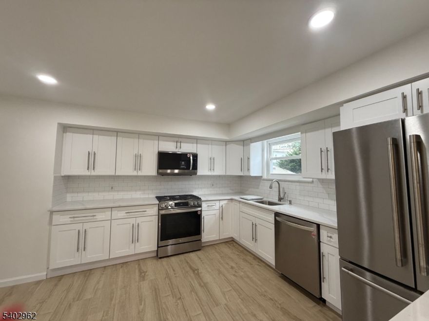 Spacious and modern, this 2,000 sq ft first-floor apartment offers 3 bedrooms and 2 full bathrooms just minutes from the heart of downtown Caldwell. The brand-new gourmet kitchen features quartz countertops, stainless steel appliances, and plenty of room to cook and entertain. Enjoy an expansive living and dining area that opens onto a private deck perfect for hosting or relaxing outdoors.This home includes two dedicated parking spaces and is situated in a quiet, convenient location close to shops, dining, and transit options. Tenant is responsible for all utilities and snow removal. Don't miss this opportunity to live in a beautifully updated apartment in one of Caldwell's most desirable neighborhoods.