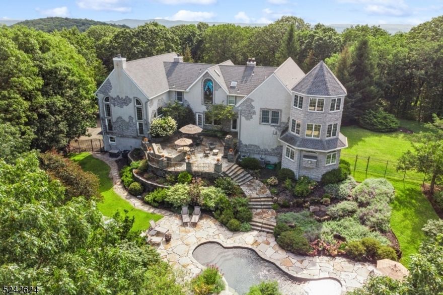 Perched atop ten acres this exceptional property offers the ultimate in sophisticated serenity. From the circular drive,step into grand foyer of this chaeteau inspired custom home and into your luxury lifestyle!  The main level is punctuated by a grand ballroom w/ fireplace and soaring windows and ceilings with additional loft living room w/ fireplace. The kitchen features Wolf appliances, granite and quartz breakfast bar and powder room.  The 1st floor also offers a cozy family room w/ a wood burning stove and convenient powder room, along with a quiet den also with a fireplace and custom bar! The adjacent dining room provides an elegant space for any occasion.The 1st floor offers a guest bedroom with an ensuite bathroom, laundry room, and the 3-level primary suite w/ fireplace, walk-in closets and en suite bathroom w/ Jacuzzi, dual vanities and staircase to the second floor multi-purpose space and turret room.  Two additional bedrooms, two w/ en suite bath, can be found on the second level, as well as a study and office. Whether entertaining or unwinding in unparalled privacy, the expanisve two tier outdoor blue stone terraces, lush with landscaping, and complete with a gunite salt water pool, the outdoor space will satisfy the most discerning buyer. The exceptional attention to detail continues in the lower level with a new nine-seat movie theater, multipurpose game room w/ herringbone ceramic tilework, a large gym, with full bath,  and access to the three-car garage.