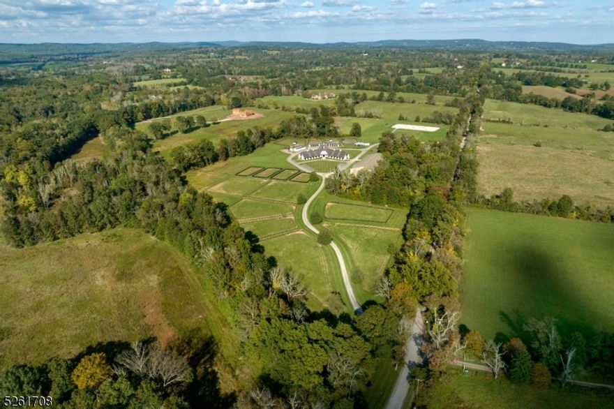 Stunning state of the art equestrian facility located in the heart of Bedminster horse country. The facility includes 22+ box stalls, grooming stalls, wash stalls, climate controlled tack rooms, 2 bath rooms, breakfast room and office. Full laundry room with washers and dryers.  Hay loft. Central hall entry which leads to three distinctive wings which are thoughtfully designed. 200' x 90' indoor riding hall with climate controlled viewing lounge which has a separate entry.  Outdoor grand prix jumper arena. Both arenas have professional footing. Over 12 fenced paddocks. There is a garage/workshop area and grooms quarters.  This is a preserved farm and is also farm assessed. 2 acre exception area for possible future home.  Easy access with a service entrance as well as the main entry.  This info is provided to serve as comparables to other equestrian properties.