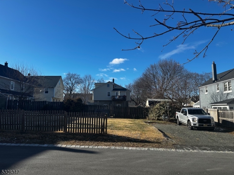 Vacant, unimproved lot within walking distance of town center, schools, and train station.