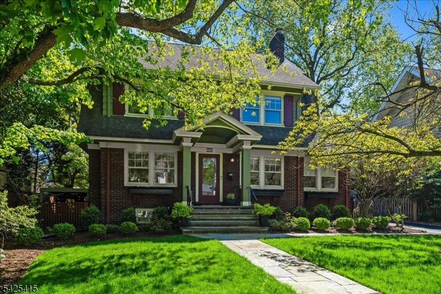 Perfectly positioned in one of Montclair's most coveted neighborhoods, this stunning 5-bedroom Craftsman Colonial seamlessly blends timeless character with modern updates. A 10-minute stroll brings you to Watchung Plaza and the NYC Midtown Direct train. One block from Brookdale Park's walking paths, dog run and open green spaces, and steps from Glen Ridge Country Club for pool, golf and tennis. Arrive to exceptional curb appeal with a newly landscaped front yard and bluestone walkway. Originally built as the neighborhood's model home in the 1920s, the house retains its gracious original details including leaded glass windows in the dining room, a wood burning fireplace in the living room and classic dental moldings. Hardwood floors throughout. A sun-drenched sunroom flows seamlessly into the living room, adding warmth and light. The first floor continues into a beautifully renovated kitchen featuring stainless steel appliances, Carrara marble countertops and ample storage. Outside, a covered porch, bluestone patio and climbing hydrangea pergola create an idyllic setting for gatherings and evenings under the stars, within a lush, fully fenced backyard with a two-car garage and charming playhouse. The second floor offers three spacious bedrooms, including one outfitted as a walk-in closet, plus a beautifully renovated hall bath. The third floor adds two additional bedrooms and a full bath, ideal for guests or a home office. This is Montclair living at its finest.