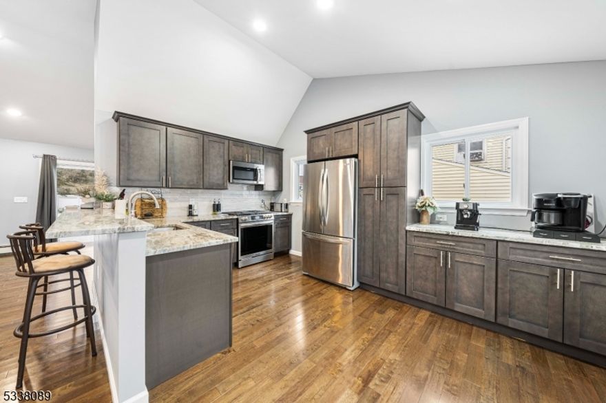 Welcome to this stunning newly rebuilt (2024) split-level home, perfectly situated in a private cul-de-sac. This modern and energy-efficient home was reconstructed from the foundation up, offering contemporary design, high-end finishes, and exceptional living spaces. The ground level features a spacious family room with access to the massive fenced-in backyard, a versatile office/den space, a bedroom, and direct entry to the attached garage and basement. The first floor boasts an open-concept kitchen with granite countertops, a breakfast bar, and stainless-steel appliances, flowing seamlessly into a bright and airy living room with vaulted ceilings and recessed lighting. Beautiful hardwood floors run throughout the home. The second floor offers three well-appointed bedrooms and a stylish full bath. A partially finished basement provides a laundry area, ample storage, and an entertainment room with endless possibilities. Step outside to your gorgeous backyard oasis, complete with an in-ground pool, covered patio, and plenty of private space perfect for entertaining or relaxation. Additional highlights include: 200-amp electrical service, Energy-efficient systems, Pull-up attic with storage, driveway with two-car parking. Don't miss this incredible opportunity to own a turn-key home in a prime location! Schedule your private showing today.