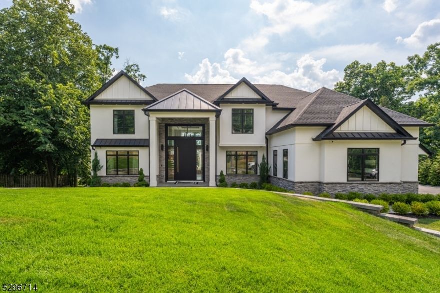 Situated within the prestigious Hills section, this exquisite colonial, built in 2020, offers a sense of seclusion while being local to shopping, dining, schools, and amenities. The grand two-story foyer welcomes you into a luxurious, naturally lit living space that flows seamlessly from the living room to the dining room and into a chef's dream kitchen that boasts custom cabinetry, a center island, and top-of-the-line appliances, including a Wolf stove top and dishwasher, and a Sub-Zero fridge, microwave, and double oven. A cozy family room complete with an electric fireplace, a half bathroom, and a home office round off this level. Ascend stairs to discover a lavish primary suite with an en suite bathroom, a walk-in closet, and a private balcony to soak in breathtaking views. A princess suite with its own bathroom, two additional bedrooms, a common bathroom, and a convenient laundry room equipped with a washer and dryer make this level perfect for everyday living. The finished basement offers endless possibilities with a billiard room, an additional bedroom, a full bathroom, and a gym. The exterior of the home is equally impressive, showcasing a stunning combination of stone and stucco with wood details, and Hardie siding that exudes curb appeal. Unwind on the deck or patio and experience the pinnacle of luxurious living as you witness unparalleled sunsets from the comforts of your own backyard. This is more than just a house; it's your new way of life.