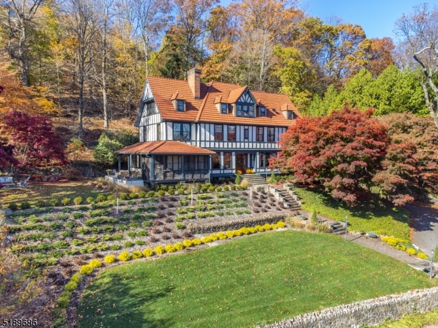 STUNNING RENOVATED TURN OF THE CENTURY COLONIAL- TUDOR WITH NEW YORK CITY SKYLINE VIEWS!  Minutes from downtown, this home consists of 6 BR, 5.1 BA & located in the coveted estate sec & over an acre of wooded land. Completely renovated with style and elegance. A true SHOWCASE- CHEF's kit equipped with high end appliances, Sub Zero , Wolf six gas burner w/ French top, Wolf double ovens, Miele Dishwasher, Wine fridge, Custom hood, center island w/leathered granite counter, Quartz, ceramic tiles, designer lighting throughout and cozy sitting area ,radiant heat in kit. Mud Rm w/built-in cabinetry. 1st Fl powder Rm off hallway. Formal DR. The grand hall entrance leads to the Living Rm with Gas FP, Built-ins & exquisite beamed ceilings. Adjacent is the Office/Library w/NYC views. -  Large Fam Rm with FP & access to the screened porch & NYC views. Entertain guests in the Solarium w/Radiant heated floors.  Second level consists of elegant Primary BR suite w/ NYC views & amazing Bathroom, your DREAM closets & dressing room, Main BA w/glass tub- shower. Cozy Den/Exercise Rm( can be used as BR) Office/BR w/BA (en suite), Laundry RM with cabinetry, storage closets. Third Flr consists of 2 additional bedrooms/Au pair suite , 2 Baths and Rec Room, 3 Car Garage - New  Doors & roof, C/A, Alarm sys, irrigation, Ext painted 2022.Extensive upgrades made to the patio & landscape & fire pit.2020, lighting 2022. Close to NYC trans. This exquisite home has it all and move in ready.