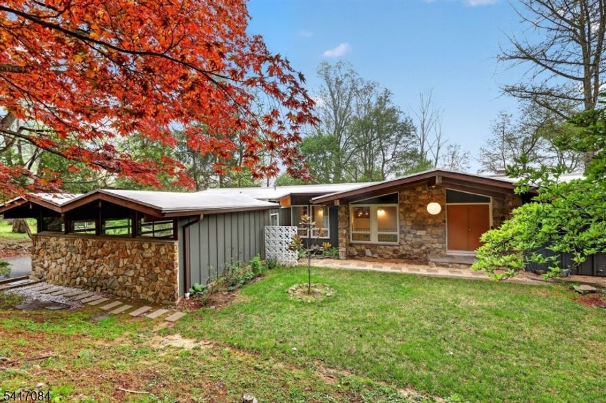 Welcome to 39 Skyline a One of a Kind Mid-century modern California ranch, located only 1.5 miles south of the Morristown Green, Beautiful secluded setting Rock Garden filled with Volcanic stones , original specimen and ornamental trees & pond. Walls of windows with skyline views.  ,  Restored with authentic sourced Lighting and design this Open plan living room with a wood-burning brick fireplace and dining room,  then step onto a newly re-finished Deck for sunset views .  Oak wood flooring on the first floor with beautiful wood beams and deck ceiling. Lower level has grade-level access to back yard with a large Carpeted Recreation Room & guest suite.  Oversized attached garage with googie architecture roof line.