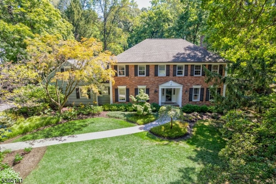 This elegant Colonial is set on a quiet cul-de-sac in one of Madison's most desirable neighborhoods. Blending timeless architecture with modern functionality, this home features a generously sized living room, a formal dining room, and a large renovated kitchen open to the family room, ideal for both everyday living and entertaining. A wall of windows fills the kitchen, designated breakfast nook, and family room with natural light, providing beautiful views of the backyard. The kitchen features abundant custom cabinetry, a large center island, Silestone countertops, high-end stainless steel appliances, and a pantry.  A convenient mudroom connects the kitchen to both the oversized two-car garage and the backyard. A home office station, powder room, and laundry room complete the first level. The second floor offers five bedrooms, three full bathrooms, and a versatile bonus room. The spacious primary suite includes two walk-in closets and a full bath with custom cabinetry, a soaking tub, a stall shower, radiant heated floors, and a double vanity. The finished basement provides exceptional additional living space, perfect for a media room, an exercise area, and a recreation room. Outdoors, the level, private backyard offers ample space for play and entertaining, highlighted by a large bluestone patio. Ideally located in one of Madison's most desirable neighborhoods, this home features classic design, generous living spaces, and a tranquil setting.