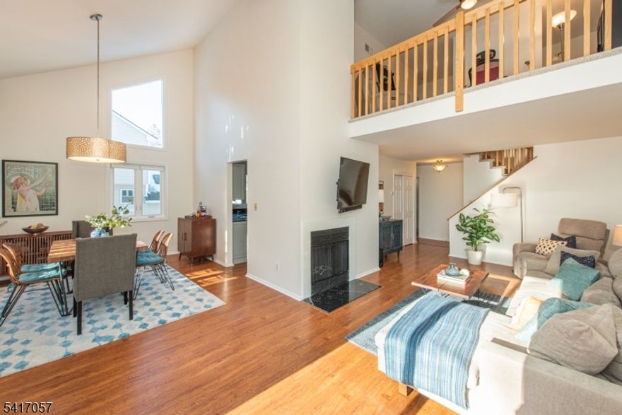 This freshly painted sun-drenched Muirfield model end unit features rare sought after convenient 1st flr en-suite primary w/tub/stall shower/walk-in closet, living room w/cozy wood-burning fireplace, spacious eat-in kitchen (granite counter/stainless appliances/plentiful cabinetry/nook w/sliders out & built-in gas line for alfresco grilling), powder room & vaulted ceiling in the elegant dining room. Upstairs boasts high ceilings in bed 2 (currently office), while top floor charms w/bed 3, generous full bath & bright loft den overlooking room below. Unit also highlights elegant wood floors, new skylights (w/solar shades), 1 car attached garage w/private driveway, new HVAC/central air, storage galore, 3 new decks, new siding/gutters/windows/sliders/garage door/insulation, unfinished dry full height expansive basement (ideal for gym/play room/den/office), guest parking/clubhouse/pool/tennis courts/playground! Near jitney to NYC train/shops/houses of worship/schools/parks/restaurants.