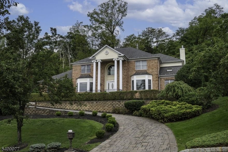 Set on a tree-lined street in the highly sought-after Montville Acres, this impressive and immaculate 5 bedroom, 4.5 bath colonial offers exceptional space, flexibility, and natural light throughout. A grand 2 story foyer welcomes you in, filled with sunlight and setting the tone for the home's bright and open feel. The main level features a formal living room and a large dining room with bay windows, crown molding, and wainscoting, along with a convenient butler's pantry. The spacious family room includes a custom built-in wall unit and a wood-burning fireplace with gas starter, and opens seamlessly to the eat-in kitchen with stainless steel appliances, granite countertops, and a center island with seating. The first floor also offers a private office and a bedroom with a full bath, ideal for guests. Upstairs, the home features two primary bedroom suites. The main suite includes hardwood flooring, a tray ceiling, a large walk-in closet, and a full bath. The second suite has its own full bath and walk-in closet. In total, there are three full bathrooms on the second level. Additional bedrooms are all generously sized. Other highlights include a 3-car garage and a finished basement providing flexible recreation space. This home is spotless, filled with sunshine, and offers a classic, stately presence from the exterior. Conveniently located near NYC transportation, shopping, restaurants, and highly rated schools.