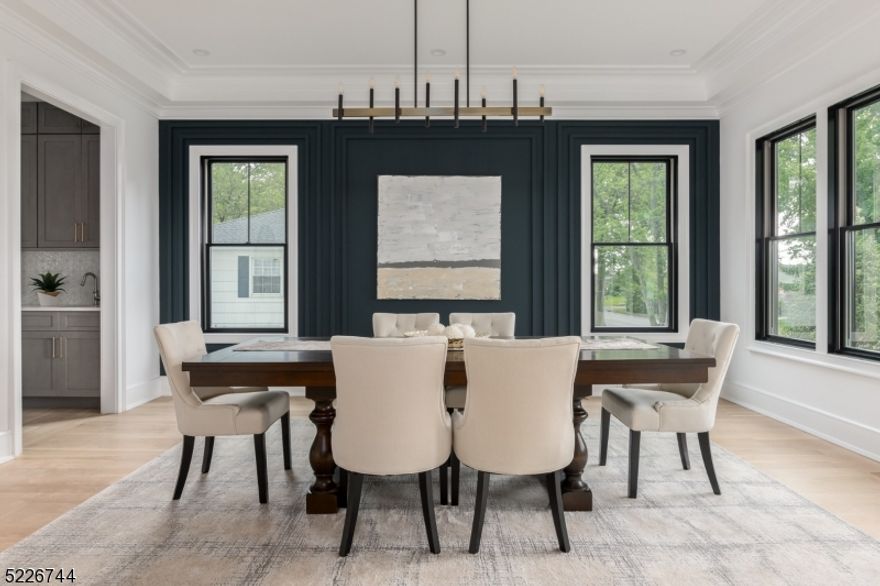 NJ's coveted Northside delivers this exquisite NEW CONSTRUCTION home for turnkey living. Situated steps away from all town offerings, this residence boasts a range of luxurious designer features and effortless flow. The gourmet chef's kitchen is a true culinary paradise with Wolf and Subzero appliances, featuring oversized island, walk-in pantry, and butlers pantry. Enjoy meals in the cozy breakfast nook, or opt for formal dining. The gracious family room provides a haven of relaxation and entertainment, with oversized sliding doors that seamlessly expand to the generous patio. Need a private retreat for work or study? The office provides the ideal sanctuary with a covered porch to bask in the serene surroundings. Venture to the second floor and discover five bedrooms, each offering a sanctuary of comfort. The primary suite is a true oasis, boasting vista views, (and seasonal city views!) exuding spa-like elegance and glamorous walk in closet.  Descend to the basement level for add'l guest quarters, recreation room, custom mudroom and 3 car oversized garage with additional storage.  Expansive, fully fenced yard invites you to embrace the outdoors and is perfect for all activities. This meticulously built home was designed by Thomas Baio, Architect with interior design by Karen B. Wolf Interiors.Top Summit Schools, World Class Shopping, Fast NYC Commute, and minutes to EWR.