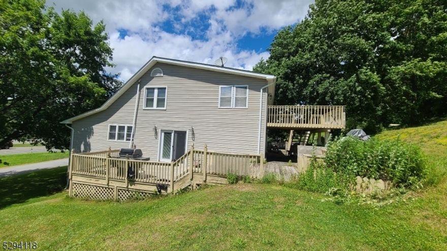 This well-maintained custom colonial single-family home is ready to move right in. 4 bedrooms, 3 Full baths on over 1 acres, you are close to shopping, restaurants, Rt 15 and 206. Enjoy open-concept living on the main floor with a large living room/dining room, a sizable kitchen complete with granite countertops and a preparation area/island. The kitchen and dining area open to a large deck overlooking a beautiful back/side yard. Off the living room is a hidden bonus office area, perfect for an office, library or den. Completing this main level is the main full bath and 1 bedroom. Upstairs you find 1 bedroom and the primary with a private deck and a 4-piece ensuite which is connected to the laundry room. The basement level is finished with its own entrance and full bath, perfect for an in-law or guest suite.