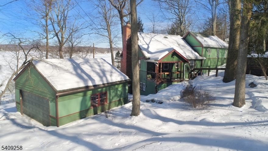 SUN FILLED Lakefront Home. Deep Water Location. # Bedrooms 2 Full Baths. Open Floor Plan with Wall of Windows to enjoy those gorgeous Lake Views. Hardwood Floors Throughout. Kitchen with Stainless Steel Appliances & Quartz Counters. Open to the Living/Dining Room with Cozy Stone Fireplace & Wood Burning Stove. Wood Beamed Ceilings adds the kind of Character & Charm a Lake Home should have!!. Master Bedroom with Vaulted Ceiling and Bay Window. Updated Master Bath with Double Sinks and Skylight. The additional second floor bedroom also enjoys those same views. The Finished Walkout lower level has a slider to one of the homes two decks for soaking in the sun. The Large decks and open floor plan are perfect for all your entertaining! Added BONUS is the 2 Car Garage! Newer Septic 2017! Get in before Spring just in Time to begin enjoying Summers here at the Lake!