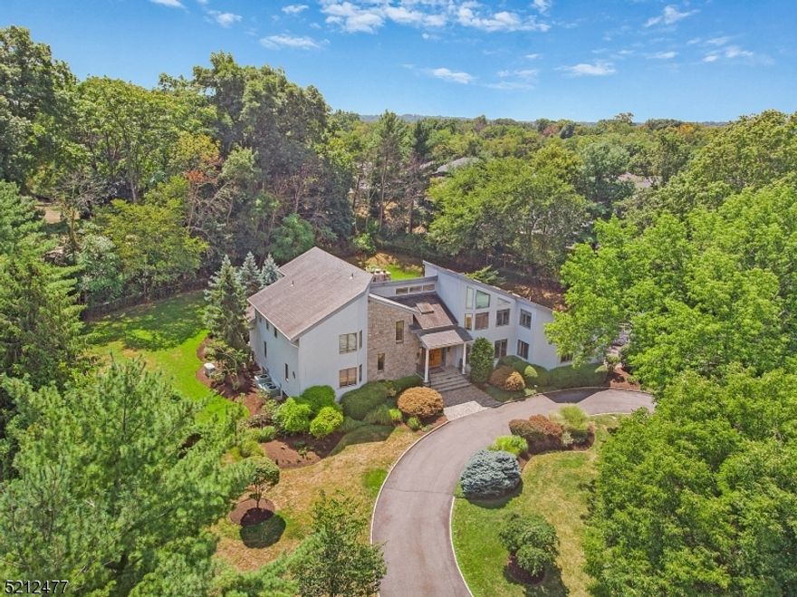 Welcome home to 12 Annabelle Lane! This spectacular custom home, sitting on one of the most coveted cul de sac locations in Florham Park boasts six spacious bedrooms and 5.5 luxurious baths, making it the perfect choice for those who love to entertain. The property offers an impressive resort-like atmosphere with over an acre of stunning manicured property, complete with a large pool and expansive deck area perfect for outdoor entertaining. Inside, the bright and airy open-concept living space boasts high ceilings, large windows, and high-end finishes throughout. The heart of the home is the stunning gourmet kitchen which features top-of-the-line appliances, ample counter space and a center island. The first floor primary suite is a true retreat, with a spacious bedroom, dressing room with custom walk-in closet, luxurious bathroom with soaking tub, walk-in shower, and sliding glass doors opening to the backyard deck. Upstairs you will find four additional bedrooms, each with plenty of space for relaxation and rest. The home's finished lower level offers even more living space, complete with an in- law suite, work out area & mudroom. Other features include a three-car garage, a home office, whole house generator and a convenient location close to shopping, dining, and entertainment. With its luxurious amenities, ample living space, and resort-like pool area, this Florham Park contemporary is an ideal choice for those seeking a luxurious and comfortable lifestyle.