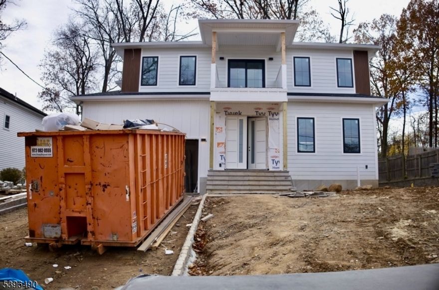 Welcome to 36 Crestview Hill Rd , Build by one of Essex County's premier builders, ICCONIC Builders. This home is conveniently close to houses of worship, top-rated schools, and major highways. offering approximately 3,500 sq. ft. of luxurious living space, this residence features 6 spacious bedrooms, 5 elegantly appointed bathrooms, and a stylish powder room, seamlessly blending modern luxury with functional design. As you enter the two-story foyer, you'll be greeted by an open layout that showcases sophisticated living and dining areas. The sunlit two-story family room is an inviting space for relaxation. The gourmet kitchen is a chef's dream, equipped with premium Thermador appliances, and it conveniently connects to a mudroom and a two-car garage. The first-floor ensuite offers flexibility, making it ideal for guests. Upstairs, the primary suite is a true retreat, featuring a custom walk-in closet and a spa-like bathroom complete with luxurious finishes. This level also includes a vaulted-ceiling bedroom with an en-suite bathroom, as well as two additional bedrooms, a full bathroom, and a dedicated laundry room. The walk-up lower level is designed for entertainment and relaxation, featuring a well-equipped gym, a media room, and a spacious recreation area complete with a wet bar. The lower level also includes an additional bedroom and a full bathroom, providing ample space for guests. all square footage is approximate.