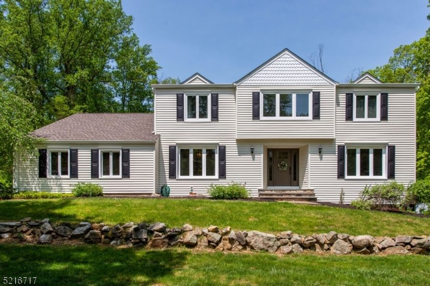 Larger Nestlingwood colonial offers backyard privacy with inground pool, 5 bedrooms, walk-out basement and more!  New porch/steps and front door welcome you to the expansive foyer, wood floors, formal living and dining rooms, family room with wood burning fireplace, huge, updated eat-in kitchen and first floor office/bedroom and full bath.  Upper level includes primary suite with 7 closets and updated full bath, 3 additional spacious bedrooms and updated main bath plus laundry room and walk-in attic storage!  Newer composite deck overlooks inground pool and expansive yard beyond!  Other features include driveway in 2021, windows 2022, new 2nd floor HVAC in 2021, roof 2018, gutters 2022, pool liner and filter 2020, new sliders to composite deck, redone in 2018, generator hookup, all oversized rooms, ample storage, perennial gardens, neighborhood with miles of sidewalks, public utilities, Long Valley schools and West Morris Central High School with IB program.