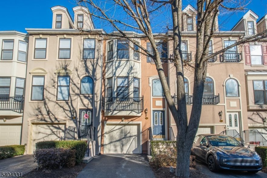 Welcome to this highly sought after Brownstone model, with over 2010 sq. ft. of living, tucked within the beautifully landscaped, gated community of Cambridge Heights.  This well-maintained home features three floors of easy living located close to the clubhouse with lovely fountain views. The first floor includes a beautiful kitchen with wood cabinets, granite countertops, like new stainless-steel appliances, a large center island that has additional storage and lots of recessed lighting.  This kitchen is open to the large formal living room that showcases a gas fireplace; the formal dining room is appointed with a bay window and custom built in window seat and designer window treatment. There are hardwood floors throughout, beautiful dentil design crown molding and a powder room. Upstairs are two generously sized bedrooms, two full baths and the laundry area. The primary includes another custom window seat, ensuite bath with deep jacuzzi tub, double sinks, and large walk-in shower. The finished lower level includes a versatile walk-out space perfect for a gym, office, family room, or bedroom. There is another half bath and access to the patio and garage with extra-large storage.Cambridge Heights features many amenities including a resort-style in-ground pool, fitness center, tennis courts, playground, walking/biking paths & clubhouse with kitchen for events. Shops, restaurants, a movie theater and an express bus are all nearby. Ideal for commuters