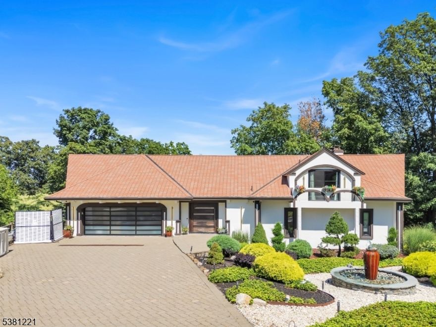 Extraordinary European style, secluded estate home with expansive panoramic & mountainviews. A PRIVATE OASIS, SPA RETREAT located at the end of a  cul-de-sac. This fully renovated villa-style showpiece offers breathtaking skyline panoramas and million-dollar views from nearly every room. Nestled on beautifully tiered, exotically landscaped grounds with architectural lighting, it perfectly blends privacy with Mediterranean elegance.Step inside through a handcrafted pivoting front door into a grand living space featuring high, soaring wood-beamed ceilings, one of three dramatic stone fireplaces, and a flowing open floor plan. Entertain in the formal dining area and gourmet chef's kitchen with quartz counters, oversized island, pro-grade appliances, and access to three expansive, newly renovated outdoor decks with lighting.The first-floor primary suite is a private retreat with deck access, fireplace, dual walk-in closets, and a spa-inspired bath with soaking tub and Euro shower. Upstairs: a home office with balcony and en-suite guest suite. The showstopping lower level includes a year-round indoor saltwater pool,4-person Jacuzzi,steam shower, dry heat sauna, and a custom walnut waterfall bar with cast-iron accents overlooking the skyline. Topped with a custom re-designed red Spanish terra-cotta roof, state-of-the-art garage w/frosted glass doors, full-house generator, smart security, and ceiling-height custom patio doors/windows that bathe the home in natural light.