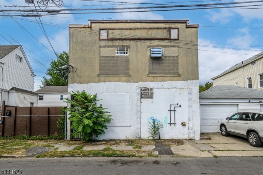 Your Next Best Investment Opportunity Awaits! Exceptional 4000 sq ft Freestanding Industrial building with 2000 sq ft lot and endless potential in thriving Paterson, ready and waiting for you! Sale of this property also includes 165 Putnam St. (B 2922 /L 21). Spanning two levels in a prime commuter location, this industrial, mix-use gem is a rarity, offering a multitude of uses with unmatched opportunity and flexibility. Prior use as a custom cabinet manufacturing facility, it offers 10 foot ceilings, 1 garage bay with potential for a 2nd, office space, 1 /2 bath, 1 full bath, and parking for 10+ vehicles. An added bonus is a vacant lot, perfect for additional parking or future development. 3 Phase power to the building. Perfectly appointed with entry across from both bustling Lyon St and Putnam St in a prime commuter location, this property is ideal for warehouse, commercial, industrial, or potential mixed-use and residential applications. It's superior location near major highways, trains, the bus line, and NYC ensures seamless connectivity. A high visibility location sure to see your business thrive. Whether you're looking to expand your current business, invest in redevelopment, or create a mix-used residential haven, this opportunity is not to be missed! Don't miss out on your chance to secure a prime piece of real estate in this bustling New Jersey market!