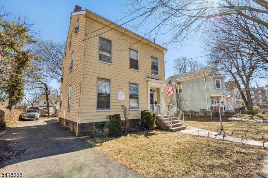 Welcome to this beautifully preserved historic Colonial home built in 1854, offering timeless character and exceptional potential. Featuring 13 spacious rooms, 3 bedrooms, and 1.5 baths, this unique property provides abundant space and flexibility for today's lifestyle. Inside, you'll find classic architectural details including hardwood floors, tall ceilings, and multiple fireplaces that showcase the home's rich history and enduring charm. Several additional bonus rooms offer endless possibilities perfect for creating extra bedrooms, a home office, playroom, library, studio, or guest space. The home also features a large enclosed rear deck, ideal for entertaining, relaxing, or enjoying gatherings year-round. Situated on a wide lot with ample parking, the property offers both space and convenience rarely found in a downtown location. Located in the heart of downtown Bloomfield, this home is just moments from parks, shopping, restaurants, schools, and public transportation with easy access to NYC, making it a fantastic opportunity for commuters and those seeking a vibrant community setting. This historic gem is being sold in as-is condition, offering a wonderful opportunity for buyers to restore, update, and make it their own while preserving its classic character. Don't miss the chance to own a piece of Bloomfield history with unlimited potential.