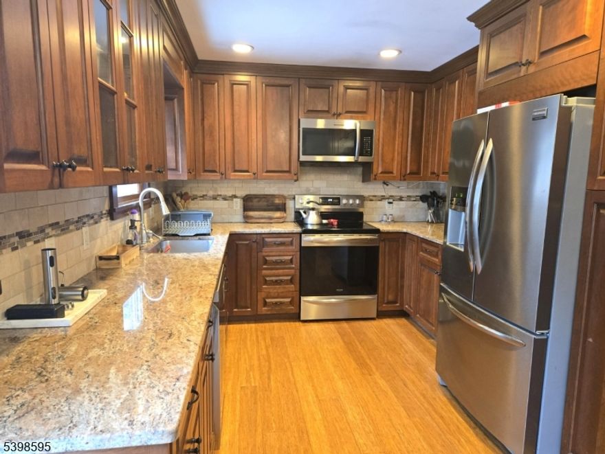 This beauty will check all those must have boxes!  Custom kitchen with granite countertops and young stainless-steel appliances.  Sliding glass doors leads to a huge composite deck overlooking the large, fenced yard. Real wood flooring, newly converted oil to gas heating system with instant hot water system.  Totally replaced front stairs and front door. Most windows replaced, 6 panel interior doors, beautiful wood railing, central air unit replace 2024. 14 x 12 young shed.  Very, very, very low electric bills approx. $16 per month, thanks to the solar panel. Conveniently located near Rt 46, 80, 206, NY transportation and Hopatcong State Park for boating, beach, lakeside restaurants, and fishing.  Highly rated school system with city water and sewer!  Quick closing available,