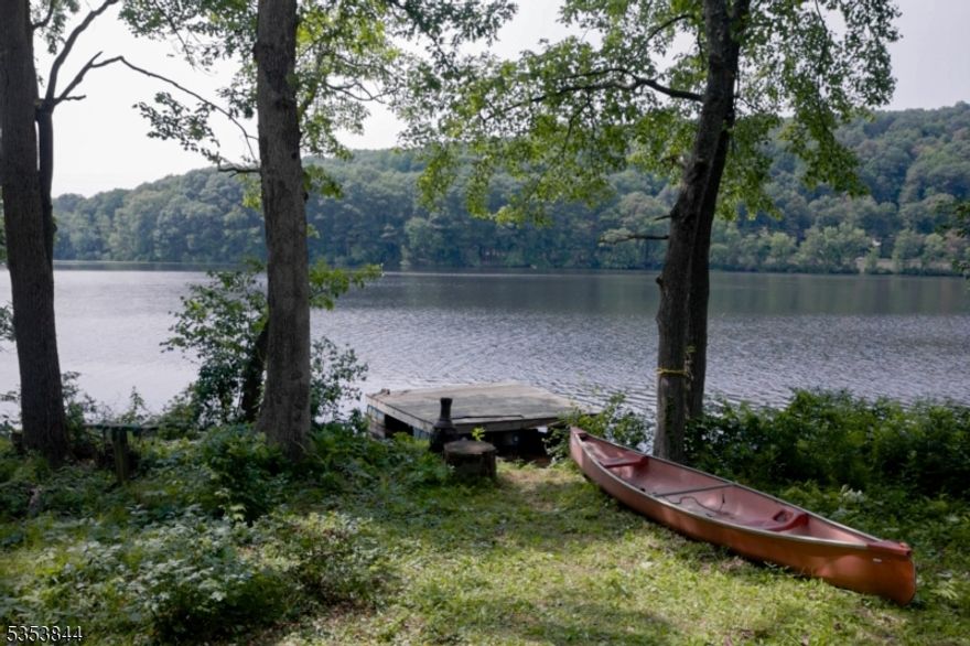 Amazing opportunity in one Northern NJ's best kept secrets -Estling Lake. A private, guarded 3 season community, Estling Lake transports you back to a time that was simpler. Camp #61 is ready for you to enjoy all the Lake days. Just 30 Steps from the deck to the lake! Enjoy all the nature & wildlife from your home amongst the 298 acres of community owned forestry. Oversized deck & front porch area. Open living room w/high, vaulted ceilings, exposed beams & a WB brick faced fireplace w/stove insert. Large, updated Eat in Kitchen w/pantry & chef grade gas oven & SS appliances. 2 1st floor bdrms & updated full bath. Convenient laundry. Upstairs, another 2 bdrms, full bath & loft overlooking the living area. Huge shed for additional storage. Own a slice of heaven as a shareholder along 64 camp Owners, all w/equal Ownership of the 80 acre lake & 298 acre forest. The community is guarded for privacy & security. Clubhouse activities & fun for all ages- ice cream social, pancake breakfast, clubs, meetings, Hub Lakes sports, etc just to name a few! Beach w/ lifeguards & diving BOArd. BOAting, fishing, swimming galore. You may feel like you're remote but you can walk to NYC direct train station (33 miles to Penn Station) & bustling DWTN Denville w/ shops, restaurants, pub & brewery. Easy access to major hwys. This is a quiet hidden spot where you get to know your neighbors. Must vacate 90 days a year. CASH ONLY PURCHASE(mortgages not accepted) No drive-bys, must have appt