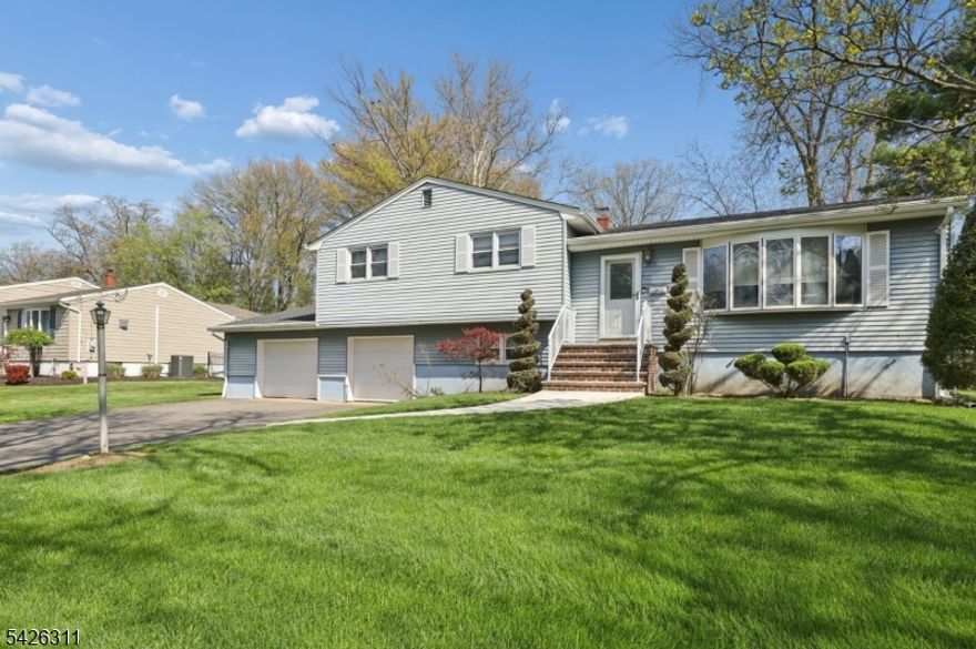 Beautifully landscaped property on quiet (dead end) street in one of the most desirable parts of Wayne.  Property features underground sprinklers. Well maintained split-level home on larger flat lot, features 3 bedrooms, 2.5 baths, and a highly functional layout that includes hardwood floors that flow through the main living and dining areas. Primary suite has private full bath, while two additional bedrooms share a full bath on second floor, each BR has built ins. Dining room/Updated kitchen open concept has sliders to deck with built in gas BBQ grill. Kitchen with stainless steel appliances and granite counter tops. The family rooms opens to a patio-perfect for entertaining. Unfinished basement offers plenty of storage with laundry room.  Two car attached garage.  Located with close proximity to plenty of shopping, major highways and NYC-bound transportation.