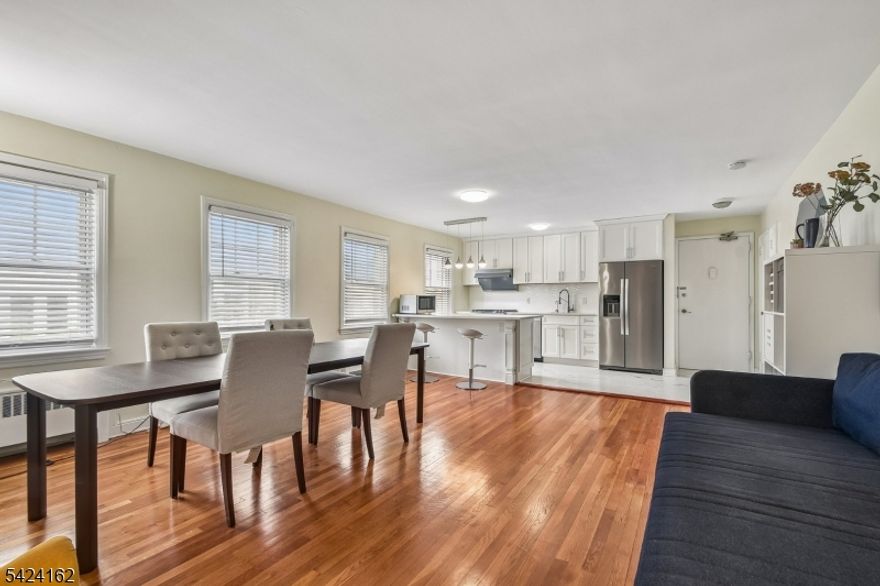This beautifully renovated, upper-level condo (#29) in Millburn Court offers effortless one-floor living with a bright, open-concept layout. Updated in 2021, the unit features two spacious bedrooms, a modern bathroom, and a chef's kitchen equipped with stainless steel appliances and ample storage. The interior is highlighted by hardwood floors, fresh paint, and newer windows throughout, while the building provides convenient amenities including heat and hot water in the rent, on-site laundry, and a designated parking space for up to two cars. Perfectly situated across from Trader Joe's and just minutes from top-rated schools, downtown shopping, and the Midtown Direct train to NYC, this well-maintained home offers an ideal blend of style and accessibility in a prime location.