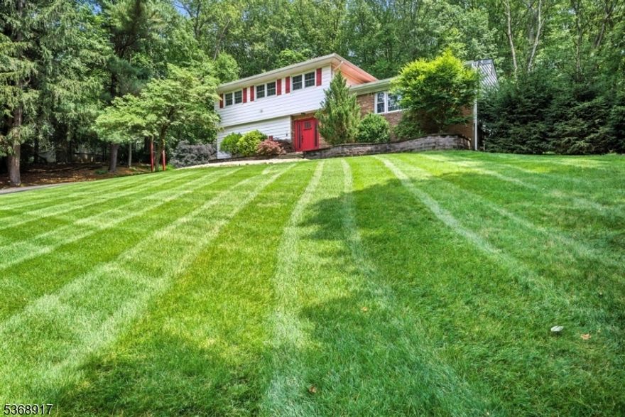 This beautiful split level home in sought after neighborhood checks all the boxes. Open Concept, hardwood floors, recessed lighting, stainless appliances, granite counters, just to name a few. You will be sold the moment you walk through the living area. OPEN concept!! Bright space w/oversized front window, sliders open to deck with beautiful views of the private park like back yard. Over an acre, wooded oasis. Large deck & patio with hot tub. Updated Kitchen equipped w/oversized center island. An ideal home for everyday living and entertaining. The second floor hosts 4 generous sized bedrooms, an updated full bath with double vanity.  Large primary suite with full bath. Ground level family Room with wood burning fireplace. Office boasts tons of windows - great option for a sunroom or reading room. Convenient laundry and powder room. Great Recreation Room w/storage in basement and flex room.. 2 car garage and plenty of parking in driveway. Public utilities, reasonable taxes, top rated schools, close proximity to Downtown, Union Hill shops & Morristown's top restaurants & shows, bus & train direct into NYC, and easy access to all major highways. Totally Move-In-Condition. Just unpack & begin to enjoy on day one, all this home, neighborhood & Denville have to offer.