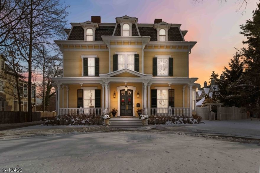 This stunning well maintained Victorian is set on a beautifully landscaped  -acre lot just blocks from NJ Transit's direct train to NYC, downtown Morristown's shops and restaurants, schools, and Morristown Airport. Inside, wide-plank hardwood floors, 12-foot ceilings, crown moldings, and five fireplaces create refined elegance throughout. The gracious living room flows seamlessly into the formal dining room and butler's pantry perfect for entertaining. The chef's kitchen features custom cabinetry, granite countertops, high-end appliances including a Wolf range, and a charming breakfast nook that opens to the inviting family room with gas fireplace and rear staircase. A powder room, laundry room, and home office with built-ins and its own fireplace complete the main level. Upstairs, original architectural details and a beautiful handrail highlight the entry to the second floor, anchored by a luxurious primary suite with two custom walk-in closets and a spa-like en-suite bath. Two additional bedrooms share a Jack-and-Jill bath, while the third floor offers four more bedrooms, a full bath, and abundant storage. The finished lower level includes a recreation room, exercise area, wine cellar, half bath, and ample storage. Outdoors, a private patio and yard provide an ideal setting for entertaining or relaxing. A fully renovated detached carriage house/ garage add exceptional flexibility. An extraordinary opportunity in the heart of Morristown.