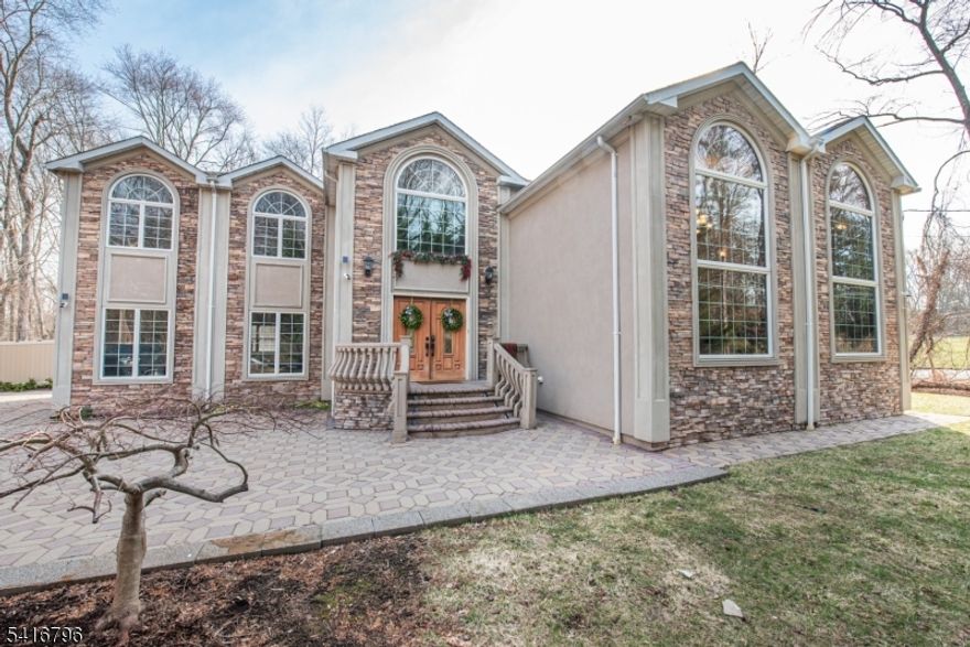 Welcome to this stunning custom-built 2006 home offering over 3,500 sq ft of beautifully designed living space with 4 bedrooms and 4.5 baths. Enter through stately double doors into a dramatic two-story foyer featuring a striking floating curved staircase, setting the tone for the home?s elegant design. Freshly painted throughout, the home showcases a breathtaking great room with soaring 20-foot ceilings, oversized picture windows, and a statement fireplace, seamlessly flowing into a spacious living room, formal dining room, and a sun-filled eat-in kitchen with natural stone countertops. The luxurious primary suite offers a private retreat with a sitting area, gas fireplace, walk-in closet, and spa-like bath, while the second level features a Juliette balcony, three additional generously sized bedrooms each with en-suite baths, and a convenient second-floor laundry. Step outside to a private, park-like backyard with mature landscaping and an in-ground heated saltwater pool (sold as-is; current owner has not opened it), ideal for relaxing or entertaining. Additional highlights include a 2-car garage with newer doors, central air, a whole-house speaker system, a surveillance system, and an exterior utility room providing access to the basement and crawl space for added storage, completing this exceptional home that blends luxury, comfort, and functionality.