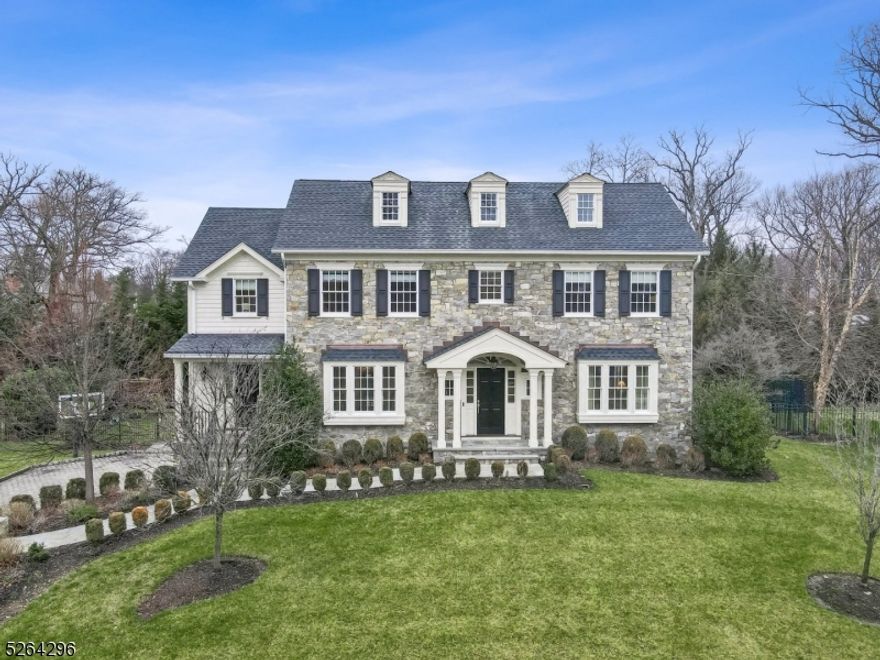 This breathtaking spacious Colonial built by renowned WP Lloyd is sure to impress and offers everything that home buyers want today including architectural interest, an open floor plan, white gourmet kitchen, finished lower level and a private yard perfectly set on a cul-de-sac in the desirable Hill section of Madison. This sun-filled home with four finished levels offers 6 bedrooms and 5.1 baths. The main floor enjoys a large foyer, a banquet size dining room, a living room, a family room with a wall of windows and a fireplace that opens to the breakfast room and kitchen. The kitchen has plenty of custom cabinetry, breakfast bar, Wolf stove, a Wolf wall oven, and a Sub Zero fridge. A walk in pantry, large mudroom with 7 cubbies, butler's pantry and powder room completes this main level. The second level boasts 4 bedrooms all en-suite and a private primary suite with a huge walk in closet and luxurious spa like bath with shower and soaking tub.  Continue to the third level and enjoy a private office that is a versatile space and a 5th bedroom, full bath and 2 storage areas.  The lower level features a recreation room, exercise room, bedroom and full bath and a 2 and 1/2 car garage. The fenced in yard has an expansive bluestone patio with stone fireplace and a built in kitchen, the perfect space to relax, entertain and enjoy the outdoors. Enjoy all Madison has to offer rated #1 town to live in by NJ Monthly in this very special home perfectly built with many upgrades!