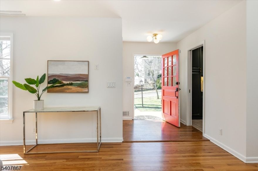 Situated on one of Maplewood's most beloved streets, this light-filled Mid-Century Modern ranch blends striking architectural character with easy connection to downtown. Just .3 mi from charming Maplewood Village - with its cafes, restaurants, shops, and the Direct train to NYC - daily life here unfolds with ease. Far more spacious than it appears, this home showcases soaring skylit ceilings, dramatic picture windows, and an expansive open living and dining space. The stunning main living area spans nearly 50 feet, creating a striking yet comfortable setting for everyday living and entertaining. The flexible layout offers multiple bedroom and office possibilities across the main level and finished lower level, including a private primary ensuite. The finished lower level features an above-ground bedroom with a separate entrance, recreation space, office area, and room for growth. Outdoor spaces feel like a private retreat. A back deck leads down to a patio, inviting year-round gatherings, while the thoughtfully designed and landscaped backyard features a tranquil pond with water features, and fire pit gathering area. Here outdoor dreams come true! Extensive updates include kitchen and bathrooms, interior and exterior painting, new storm doors, reinforced retaining wall, driveway with French drains, garage doors, recessed lighting, electrical upgrades, whole-house generator, and new dishwasher (2026). This is absolutely the Maplewood GEM that you've been hoping for!