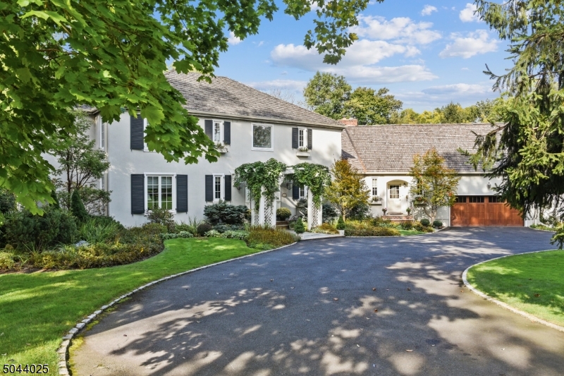 On 1.1 acres this 6 bedroom, 6.1 bath, bright and airy Colonial is a blend of old world charm and modern touches. An entertainer s dream.  Built in 1986.  Parklike grounds with saltwater pool. Enter this approximately 8,000 SF spacious custom home through the solid wood door known as  Four Winds  that was handcarved in Taos, NM.  Sun drenched light from an abundance of oversized windows provide a bright & airy feel.  Grand scale Living Room, Dining Room, Kitchen & Family Room are ideal for entertaining. A separate staircase leads to a suite that includes a Living Room, Kitchenette, Bedroom & Full Bath. A first floor en-suite guest Bedroom provides private quarters for visitors.  Outdoors, a blue stone patio, a pool with hot tub & professionally landscaped private property complete this private retreat.