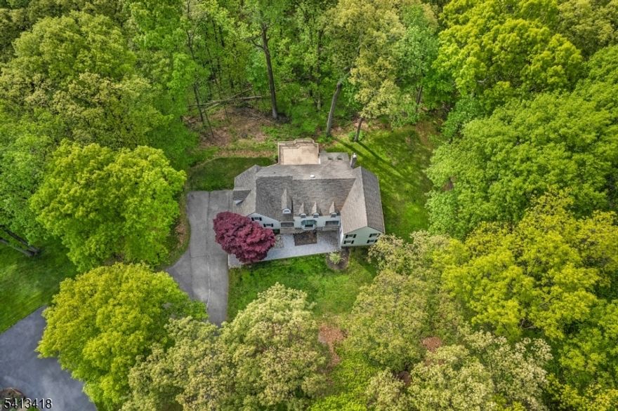 Tucked away at the end of a quiet cul-de-sac on 4.73 breathtaking acres in coveted Chester Township, this fully reimagined 4,437-square-foot Colonial is the definition of modern luxury meets timeless sophistication. Every inch of this four-bedroom, four-bath home has been elevated with intention, from the fresh interior and exterior paint to the wide-plank LVP flooring, designer finishes, and custom architectural details throughout. The heart of the home is a stunning chef's kitchen designed to impress, featuring sleek quartz countertops, premium Caf  Appliances appliances, and an effortless open-concept flow perfect for entertaining on any scale. Sophisticated designer wallpaper transforms the dining room into a true statement space, while custom millwork, elegant paneling, shadow box molding, recessed lighting, and refined trim work create a level of detail rarely found at this price point. The primary suite and guest baths have been beautifully updated with a clean, elevated aesthetic that feels straight from the pages of a luxury design magazine. New interior doors and brand-new garage doors further enhance the seamless, turnkey feel of the home. Set against a backdrop of privacy, mature trees, and picturesque acreage, this is more than just a home, it's a lifestyle property that delivers the rare combination of luxury, land, and location in one of Chester Township's most sought-after settings.