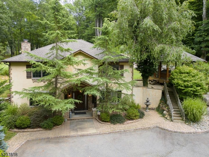 Come see this amazing Tuscan style Villa in Denville!  This home has a Gazebo and multi-level patios to sit and relax and enjoy the beauty of 1.89 acres of private wooded property.  Enter the front door to the immaculately kept home with custom tile work throughout. Updated kitchen with new Dekton countertops, custom wood cabinets, SS 5 burner range, dual fridge and freezer and walk in pantry for amazing storage.  Bambo flooring in the open flow DR/FR with raised hearth stone FP.  MBR has tray ceiling, sliders to private patio and spa like bath with dual vanities, jetted tub, walk in Euro Style shower with body jets.  There are 2 additional large bedrooms. This home boasts storage all over including storage above the 2-car detached garage.  Plenty of parking on the property!