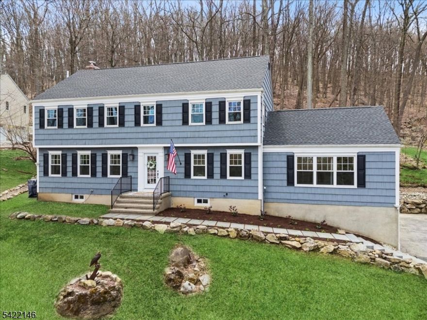 Beautifully renovated Colonial set on approximately 1/2 acre within the sought-after Panther Valley community. Enjoy gated entry and resort-style amenities including 3 pools, tennis and pickleball courts, playgrounds, scenic lakes, and access to a private 18-hole golf course and country club. Convenient to shopping, dining, and charming downtown Hackettstown. Inside, rich hardwood floors, crown molding, and abundant natural light enhance the thoughtfully designed living spaces. The inviting layout flows from the foyer to a formal living room and an elegant dining room featuring picture frame molding. The spacious kitchen is equipped with high-end appliances, quartz countertops, generous cabinetry, pantry, and an oversized island, opening to a breakfast area and sitting room with a fireplace.Step outside to a stunning bluestone patio designed for entertaining, complete with a pergola, firepit area, and gazebo. The main level also features a powder room and a large family room with a workstation and wet bar. Upstairs, the primary suite offers a WIC and en-suite bath with dual vanities, along with 3 additional bedrooms and a full hall bath. The lower level includes a laundry area, workshop, garage access, and ample storage. Major updates within the past 5 years include roof, windows, and water heater, plus a whole- house water filtration and humidifier system. Move-in ready and meticulously maintained.