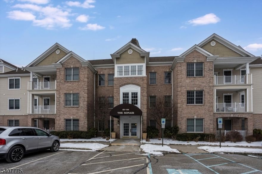 Welcome to sought after Horizons at Ridgeview, an active 55+ community just 2 miles from Route 80 & Mt. Arlington Train/Bus station yet minutes from Lake Hopatcong and all its amenities! Available for quick closing! 2nd floor freshly painted end unit offering two bedrooms & two baths. Enjoy the open floor plan with plenty of natural light. Kitchen with 42" cabinets, center island, pantry & new SS appliances. Spacious living room with private balcony perfect for relaxing. An additional living space can serve as den or dining room. The kitchen features extended length wood cabinetry and a convenient breakfast bar, open to a spacious living room and sliders leading to a balcony, perfect for morning coffee.  Large primary bedroom with walk-in closet, private bath with soaking tub and shower. Second bedroom has double closets with an area for a sitting room or office. Laundry room with full size washer and dryer. Elevator access to the unit. Horizons community features association pool, tennis courts, picnic area, clubhouse and more! 1 assigned garage spot and additional outside shared spots. Within walking distance of Mt. Arlington Library and public beach on Lake Hopatcong is a few minutes' walk or drive. Basic cable (1 box) and internet are included in HOA fees. There is a two pet maximum each under 40 lbs  No residents under 19 permitted, at least one resident must be 55+. There is 1 assigned garage spot with storage closet plus additional outside shared spots.