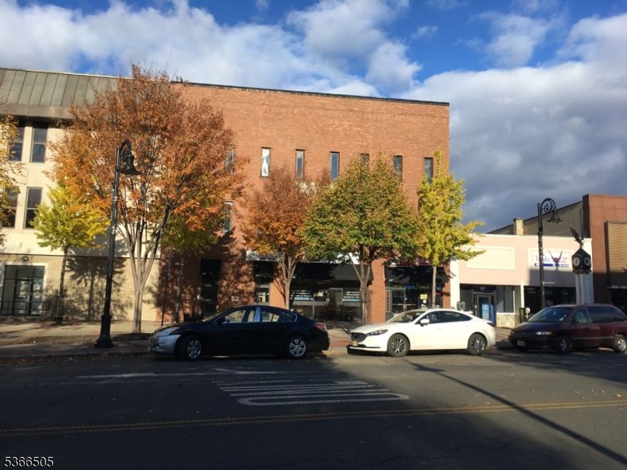 Step into ownership of this impressive 17,373 square foot mixed-use commercial building, perfectly positioned in the heart of bustling downtown Plainfield. This substantial 3-story plus partially finished basement property underwent complete gut reconstruction in 2017, transforming historic 1925 architecture into a state-of-the-art commercial facility.