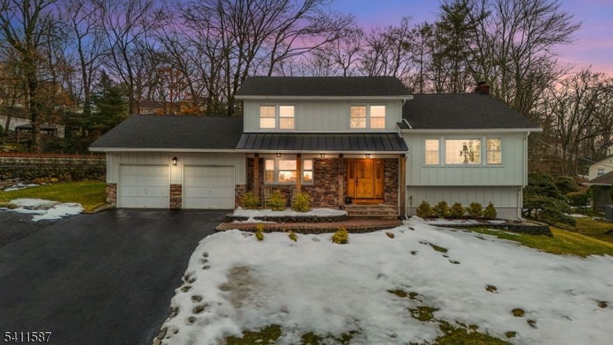 Renovated kitchen, charming front porch, spacious living areas, deck and stone patio, & flexible bonus space come together in this beautifully updated home(2022). A welcoming front porch sets the tone and offers the perfect place to enjoy morning coffee or unwind in the evening. Inside, hardwood floors and abundant natural light create a warm & inviting feel throughout the main living spaces. A bright living room provides a comfortable place to relax, while the inviting family room with fireplace & built-ins creates the perfect setting for everyday living or gathering. The renovated chef's kitchen is the centerpiece of the home. It features crisp white cabinetry, stainless steel appliances, a striking statement range hood, generous prep space, and a large center island with seating and a built-in wine refrigerator. Thoughtful details including wood beam accents, Edison-style pendant lighting,shiplap touches, and a sliding barn door add warmth and character while maintaining a fresh, modern style. The kitchen flows seamlessly into the dining and living areas, creating an open layout ideal for everyday living and entertaining. The home offers four spacious bedrooms, including a primary suite with an updated ensuite bath featuring modern finishes and a walk-in glass shower. Outdoor living includes a large deck and stone patio overlooking the yard. Enjoy all that Wayne offers including great schools, parks, shopping, dining, major highways, & convenient NYC transportation.