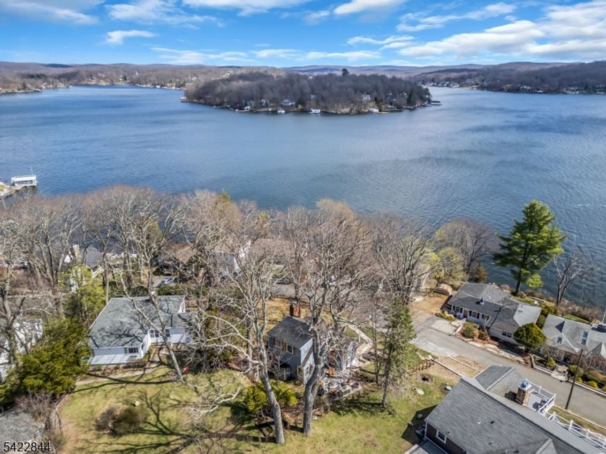 HIGHEST AND BEST Tuesday 4/14 NOON. Expansive Main Lake Views & Low Taxes! Welcome to this beautifully updated 3-bed, 2-bath home offering a rare mix of cozy character and easy lake living. Just across the street from the lake, this inviting home features a private upper-level primary suite with its own bath and WIC. The main living space is packed with style and warmth thanks to a custom wood mantel, shiplap accent wall, built-ins, crown molding, pass-through ledge, pellet stove insert and lake views all around. The kitchen offers granite countertops, stainless appliances, soft-close drawers, brushed nickel hardware and reverse osmosis filtration. Major updates include renovated main bath-2020, mini-splits-2021, new deck-2021, bluestone patio-2019, updated electric and plumbing in 2019, 3bed septic-2017, whole-house filter and water softener-2025, hot water heater-2026, and a brand-new roof-2026. Outside, enjoy a fire with a killer view from your grilling area. Extra storage in the outdoor shed and basement workshop, all on a small, easy-to-maintain property. Whether you're searching for a first home or the perfect second home near the lake, this one delivers big charm without big maintenance. Bonus - Enjoy the amenities of Wildwood Shores- 4 private lakefront access points w/sandy beaches, fishing docks, clubhouse & optional boat/jetski dock rentals. This HOA-protected enclave allows NO short-term rentals- the ideal blend of peace, community, and recreation.